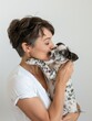 Intimate moment between a woman and her Dalmatian puppy, evoking love and companionship.