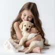 A joyful young girl cuddles with a fluffy golden retriever puppy on a white background.