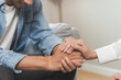 © Pormezz - mental health issues concept, doctor touching patient hand showing empathy during depression therapy session.