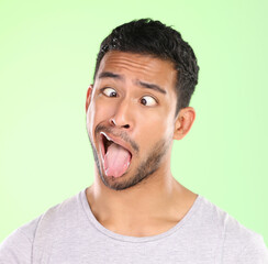 Sticker - Man, crosses eyes and tongue in studio, silly and goofy comic or funny face on green background. Male person, mockup space and emoji for joke or comedy humor, student and quirky or crazy character