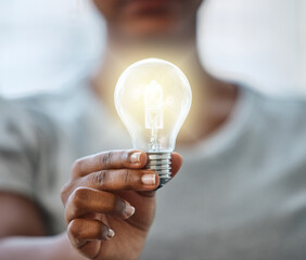 Business, woman and hand with light bulb for idea, innovation and creative knowledge for vision for sustainability. Growth, solution and renewable energy, electricity and power saving for eco plan