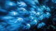 Underwater art and photography capturing a group of fish illuminated by blue light