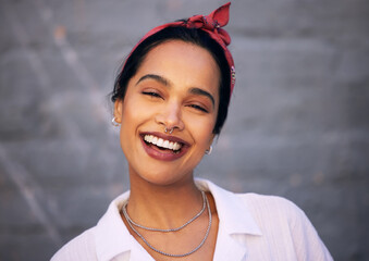 Woman, portrait and smile with wall background in city with jewellery accessories, gen z or downtown. Female person, face and laughing for funny joke or urban traveling in Mexico, piercing or fashion