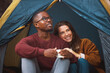© peopleimages.com - Camping, nature and couple embrace in tent with morning drink, happy vacation or romantic date. Relax, man and woman bonding together on holiday with coffee, hug and calm outdoor adventure in woods.