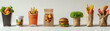 A row of food items including hamburgers, fries, and a salad