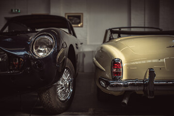 Classic cars being restored in a vintage vehicle garage workshop