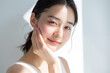 © wazamai - Portrait of a serene Asian woman with a subtle smile and clear skin