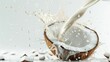 Fresh coconut milk being poured into a half open coconut on white background, tropical beverage concept