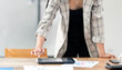 Businesswoman using digital tablet standing in office.
