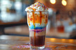 artistic layered rainbow iced coffee with creamy topping and colorful background