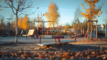 Soft Focus Panorama Of A Child’s Play Area With A Seesaw And Play Tools Centrally Located On A Winter Daybreak. A Skateboard Is Evident Near Some Yellow Poplars. With Youngsters Having Fun Around It. 