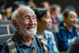 Fototapeta  - Close-up view of an elderly male audience member listening intently during a seminar or conference, represents lifelong learning