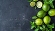 Fresh mint and ripe limes flat lay, template for menu or recipe, on dark background