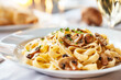 tasty tagliatelle or linguine pasta with mushrooms and parmesan, close up
