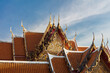 Decorative rooftop in red tile and golden trim, at the Marble Temple (Wat Benchamabophit Dusitvanaram), Bangkok, thailand.
