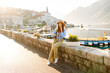 © maxbelchenko - Young female tourist is photographed against the backdrop of attractions.  Lifestyle, travel, rest, weekend, active life.