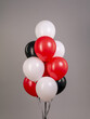 Fountain of balloons with helium on a gray background