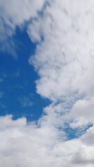 Wall Mural - time lapse fast moving white clouds and blue sky.
