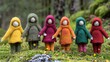 Girl friend dolls are standing in the forest, their outfits are in different colors. Toys made of wool by felting technology. Fairy-tale character. Handmade. Design for cover, card, postcard, etc.