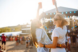 Fototapeta Kuchnia - Beach party. Two young woman with beer at music festival. Summer holiday, vacation concept.