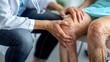 © Pravinrus - A doctor is examining the knee of an elderly patient who has osteoarthritis.