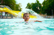 A little boy swimming in a beautiful blue pool with an inflatable circle. Child drowning in the pool	