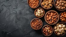 Mixed Nuts In Wooden Bowls On Black Stone Table Almonds Pistachio Walnuts Cashew Hazelnut Top View Nut Photo, Generated With AI