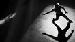 © Artyom - Silhouette of person breakdancing with dramatic shadow