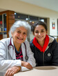 © Kostya - Woman with stethoscope sitting next to older woman.