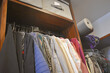 Closet with shelves and hanging clothes