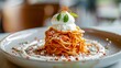 A bolognese-style vermicelli pasta with parmigiano cheese on top and white cream. Elegant Italian dish of vermicelli pasta with special cheese.