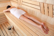 Young woman relaxing in sauna, top view. Spa treatment concept