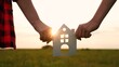 hands holding paper house, window sunset ray, happy family mortgage build new house, building a new home, fixing credit for mortgage, moving day essentials, downsize your home, kerb appeal