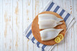 Fresh raw squid fillet with lemons. A large portion of squid is prepared for cooking. Top view.