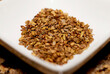 Close up of organic dry roasted fennel seed on a white ceramic plate