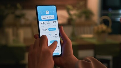 Woman buys plane tickets online. Choosing seats in a plane using booking app for mobile phone.