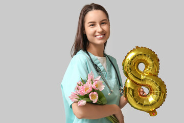 Poster - Female doctor with pink tulips and balloon in shape of figure 8 on white background. Women's Day celebration