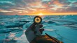 A hand holding a compass in front of a frozen lake during sunset
