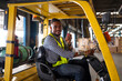 © kelvn - Warehouse worker driver in uniform delivery and loading pallet product by forklift.