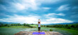 Asian woman relax in the holiday. Play if yoga. On the balcony landscape Natural Field