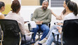 © peopleimages.com - Sad, man and counselling meeting with people for group therapy, support and sharing feelings for healing. Workshop, therapist and empathy for mental health, depression and understanding together.