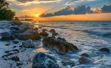 Sunset On The Beach, Sunset Over The Rocky Shore Of The Gulf Of Mexico At Caspersen Beach In Venice Florida