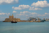 Fototapeta Pomosty - View of the fortress and entrance to the Mandraki port in Rhodes, Rhodes Island, Rhodes city, Greece