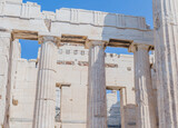 Fototapeta Desenie - Ancient Greek temple facade with towering columns and stone blocks, in Athens Greece