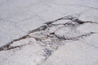 The old badly damaged concrete street background with collapsed and broken crack texture on surface