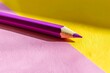Purple school pencil on a yellow pink background. Modern conceptual art. Purple school pencil with shadow on a pink yellow background. Modern conceptual art. .