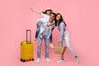 © Home-stock - Traveler parents with child girl sit on father back, posing with suitcase isolated on pink background, ready to travel abroad in free time