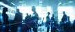 © Iona - Silhouettes of business professionals in blue-toned office, digital network overlay suggests technology and connectivity.