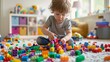 Little Toddler Playing with Multicolored Blocks, Focused and Creative