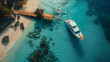 Aerial view of luxury yacht anchored in tropical exotic island beach with crystal clear turquoise water.